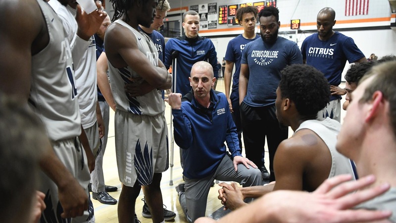 Head Coach Brett Lauer talks to his team at a timeout.