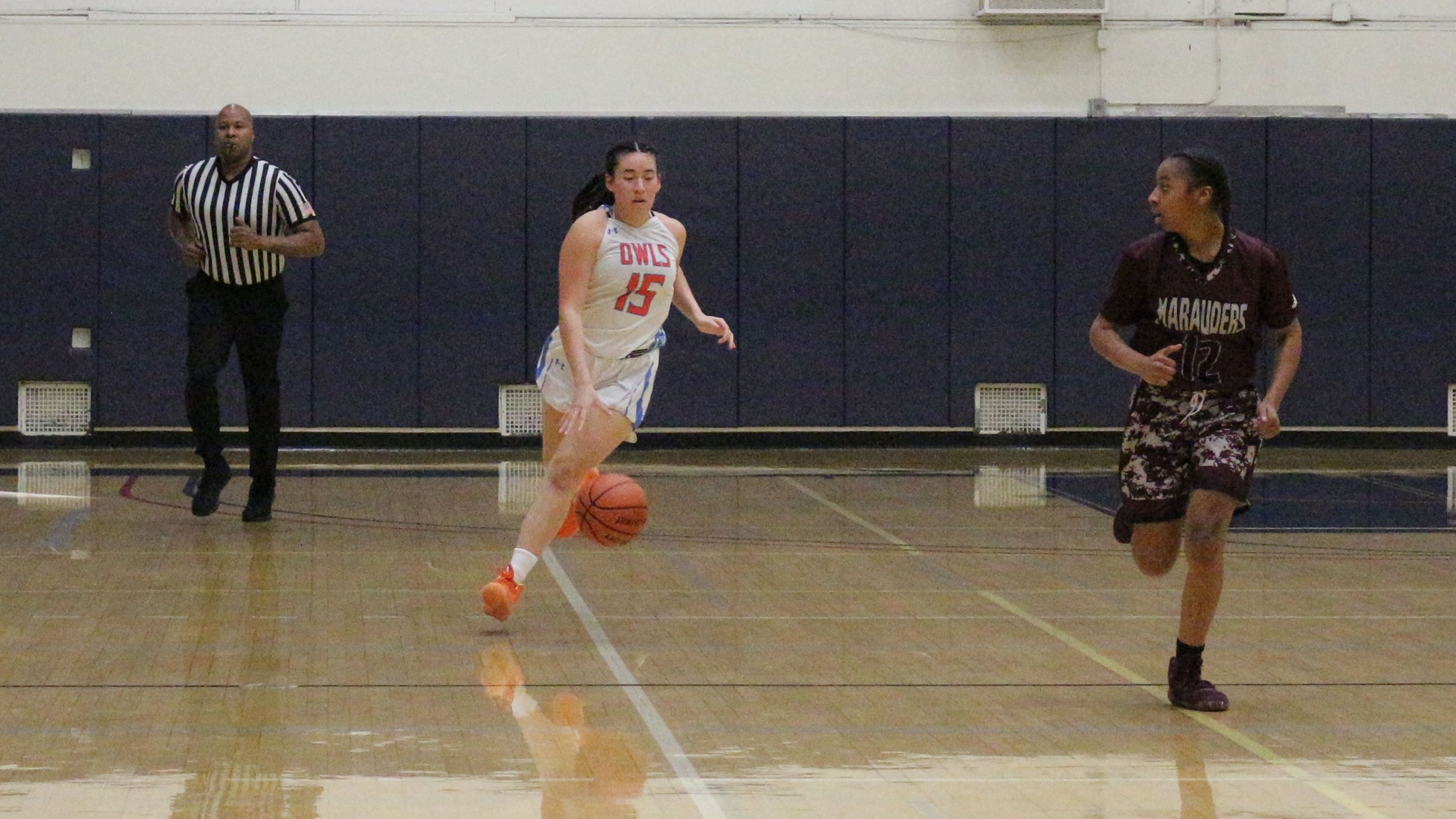 Julie Garcia Mann dribbles down the court. Photo by: Brianna Jara